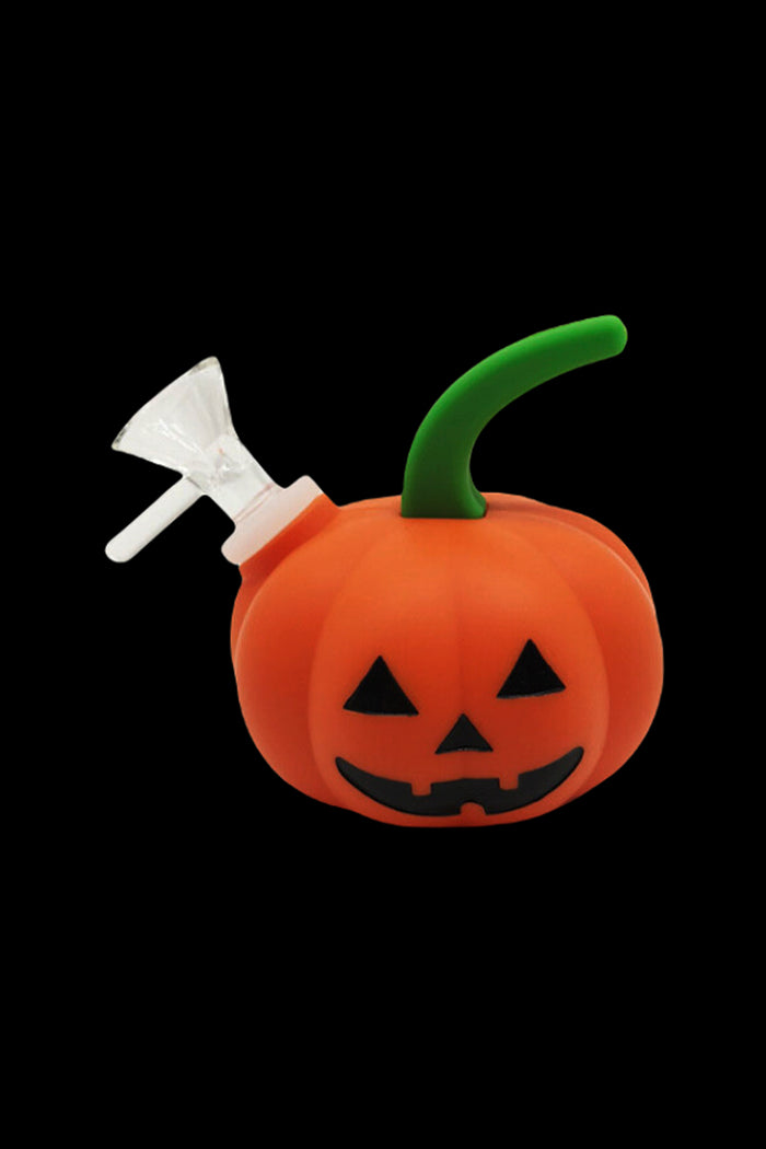 Halloween-themed orange pumpkin-shaped water pipe with a silver mouthpiece and green stem, isolated on a black background.