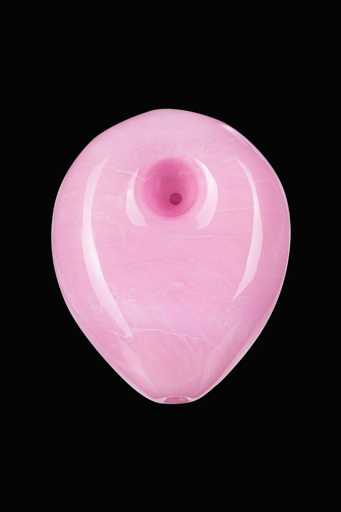 A studio shot of the Empire Glassworks "Pink Panther" hand pipe, showcasing its smooth, curved form against a plain white background.