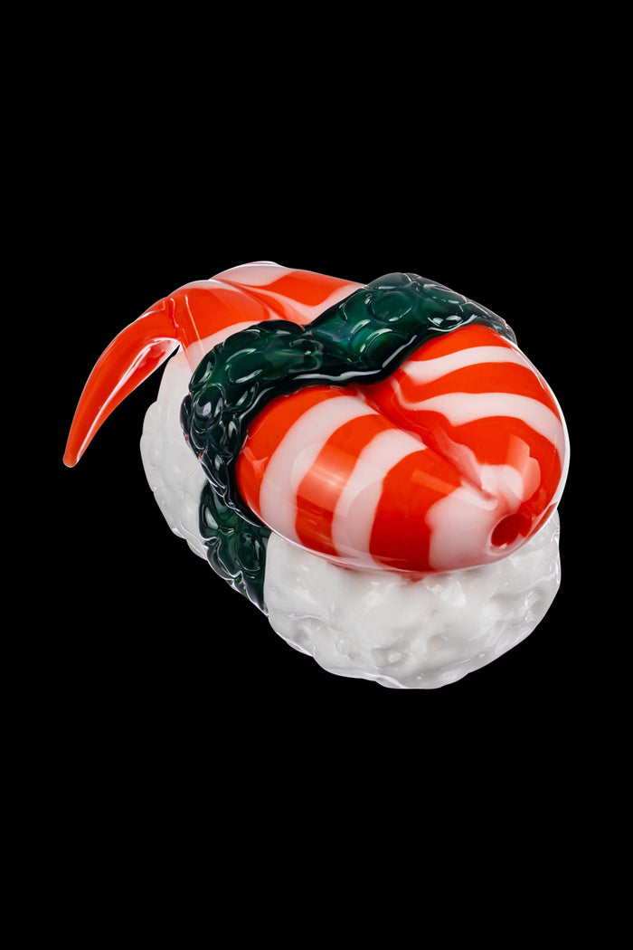 A close-up, angled view of the Empire Glassworks Shrimp Nigiri Sushi Hand Pipe, sculpted to resemble a piece of sushi.
