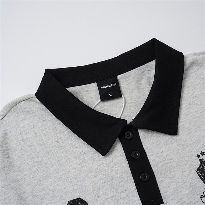 Close-up of the gray polo shirt's black collar, label, and three-button placket