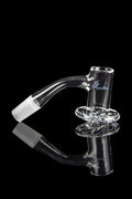 Clear glass cannabis oil rig with a curved neck and circular base, reflected on a black surface.