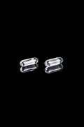 Clear glass cannabis capsules against a black background.