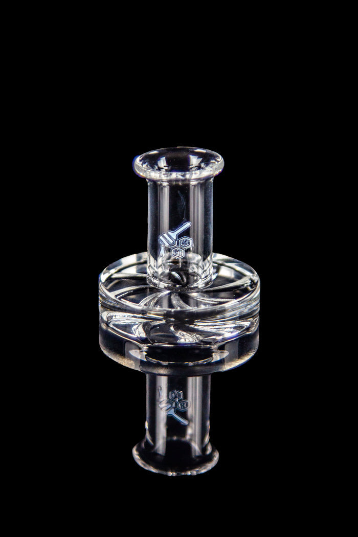 Clear glass dab rig with intricate design against a black background.