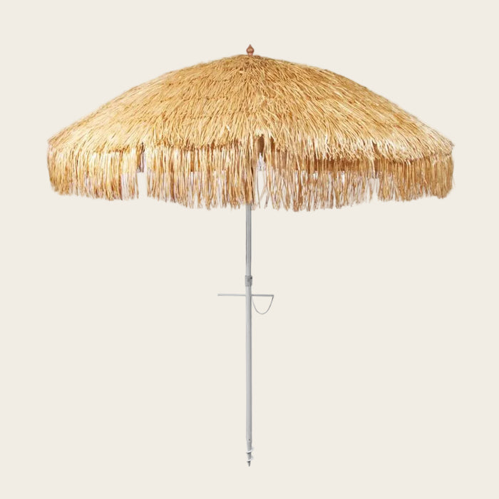 Hula 210cm Beach Umbrella with raffia thatch canopy, anodised pole, quick-twist sand anchor, 3-way tilt, UPF 50+ UV protection, and wind-vented top for beach shade and resort style.