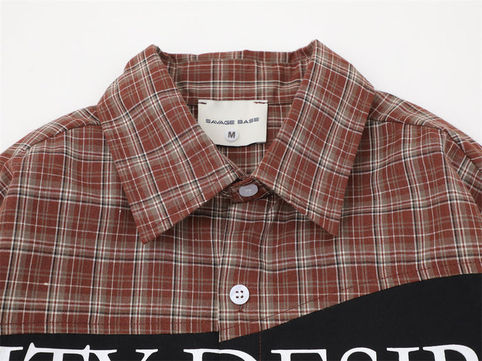 Close-up of the red plaid shirt collar, top button, white stitching, and sewn-in neck label