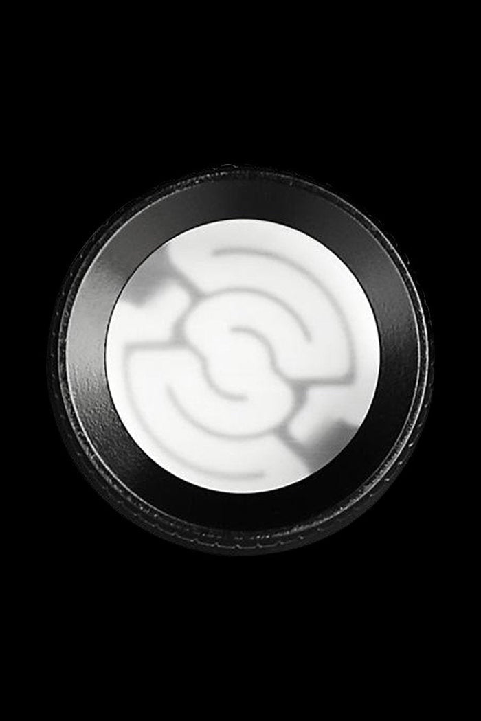 Close-up of a white cannabis concentrate inside a black container.