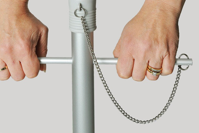 Close-up of hands turning the Quik Twist self-anchoring auger on a Rainbow 240cm Beach Umbrella pole