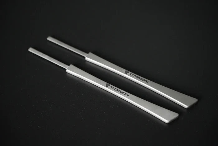 A close-up image of a titanium bread lame, showing its ergonomic handle with "Titanion" logo