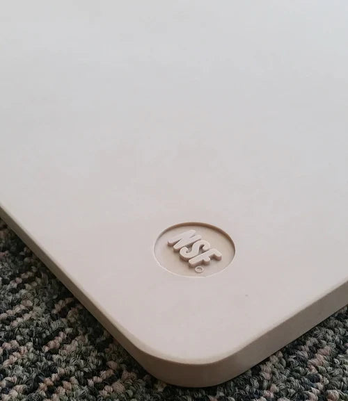 NSF logo shown on beige cutting board.