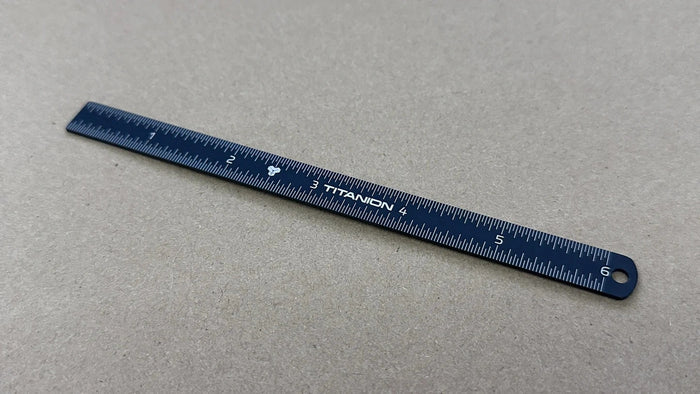 Blue Titanion Pocket Ruler 6 inch or 15cm on tabletop.
