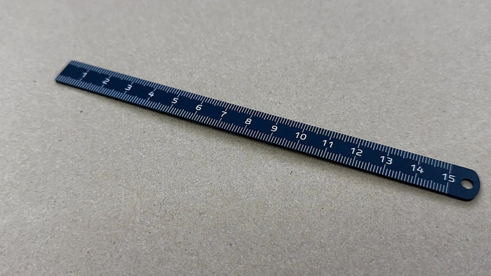 Blue Titanion Pocket Ruler 6 inch or 15cm on tabletop.