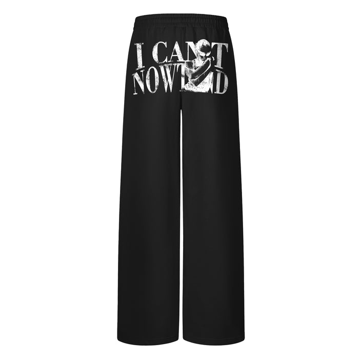 Black wide-leg sweatpants with a bold white graphic print across the front waistband area